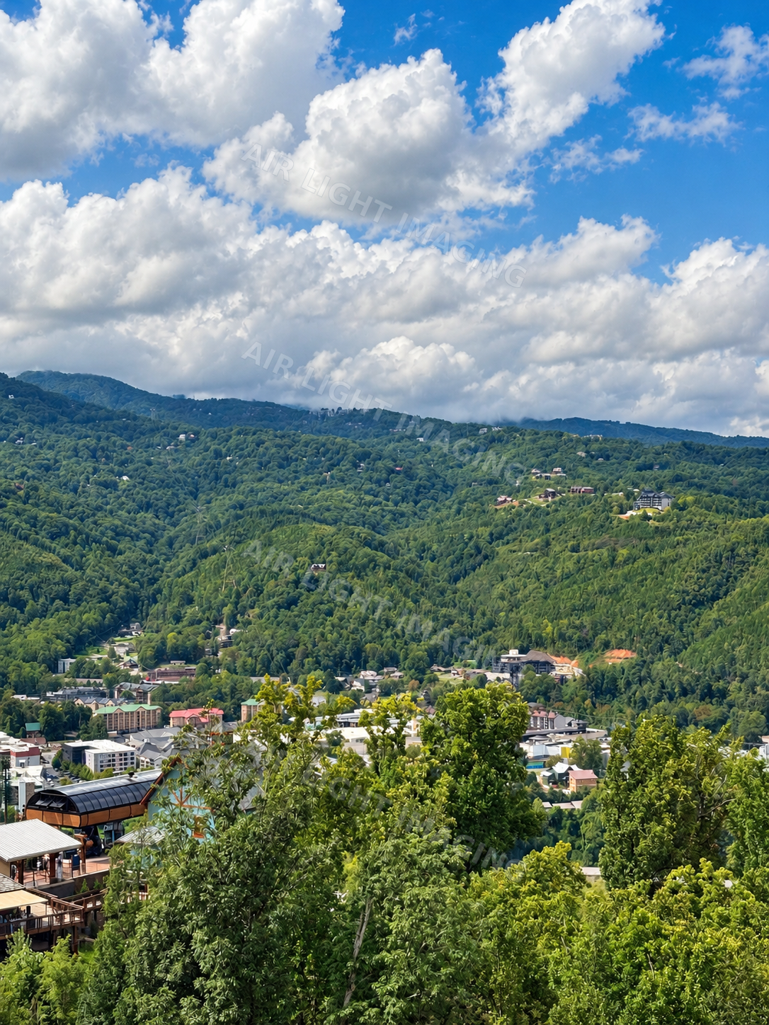 Mountain town beneath large summer clouds